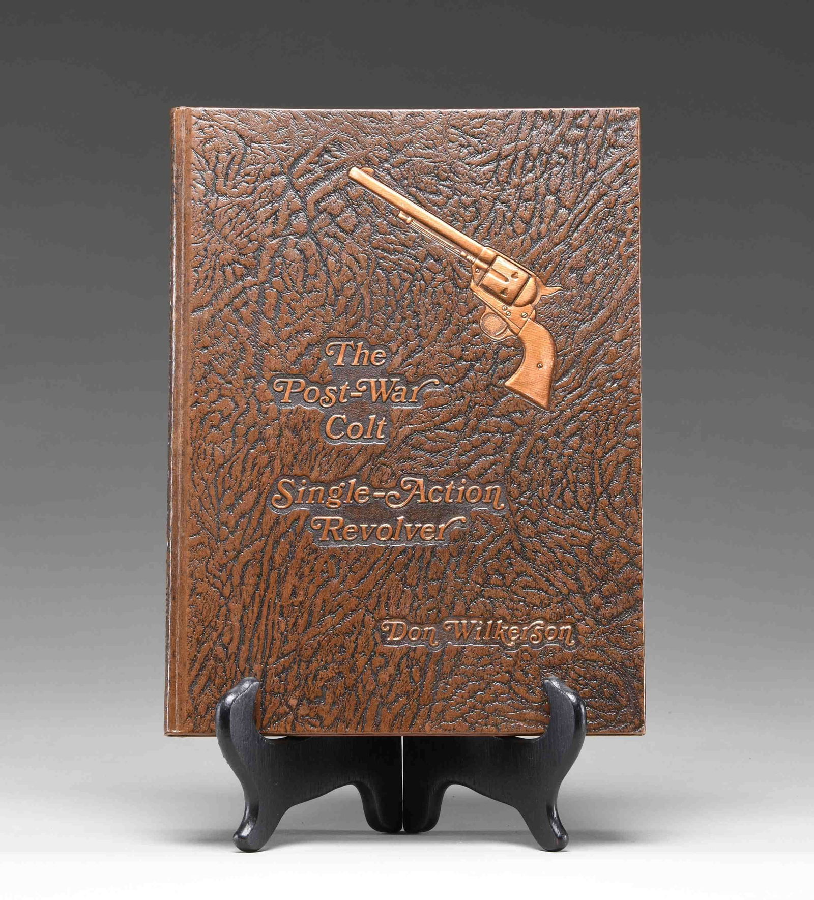 1ST EDITION PROOF COPY OF "THE POST-WAR COLT: SINGLE-ACTION REVOLVER", BY DON WILKERSON. 1st edition print copy of "The Post-War Colt Single-Action Revolver", by Don Wilkerson. Brown leather cover, with gold highlighted characters and SAA graphic