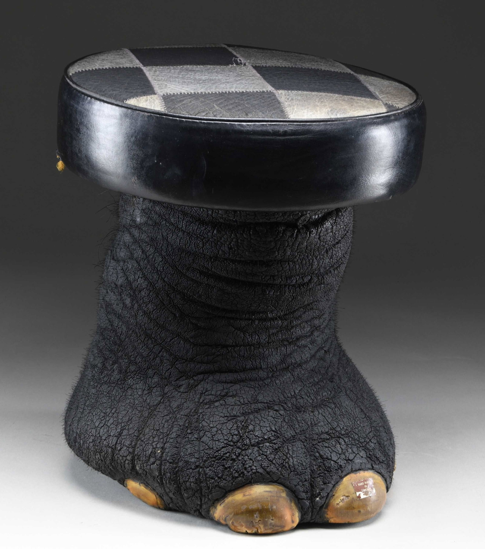 REAL ELEPHANT FOOT MADE INTO A FOOT STOOL OR: SITTING STOOL. This elephant foot has been made into a sitting stool or foot stool by local craftsmen in India. This example measures approximately 16" in height and approximately 13 1/2" in width at 