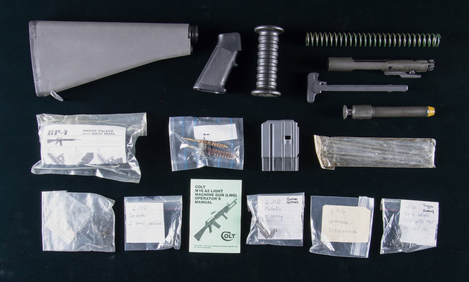 COLT M16A2 LMG PARTS LOT.: This lot consists of the following parts for the Colt M16A2 LMG: 1) Colt LMG Manual. 2) LMG Vertical foregrip. 3) Pistol grip Assembly. 4) LMG Buffer Tube. 5) LMG Bolt Carrier Group & charging handle.
