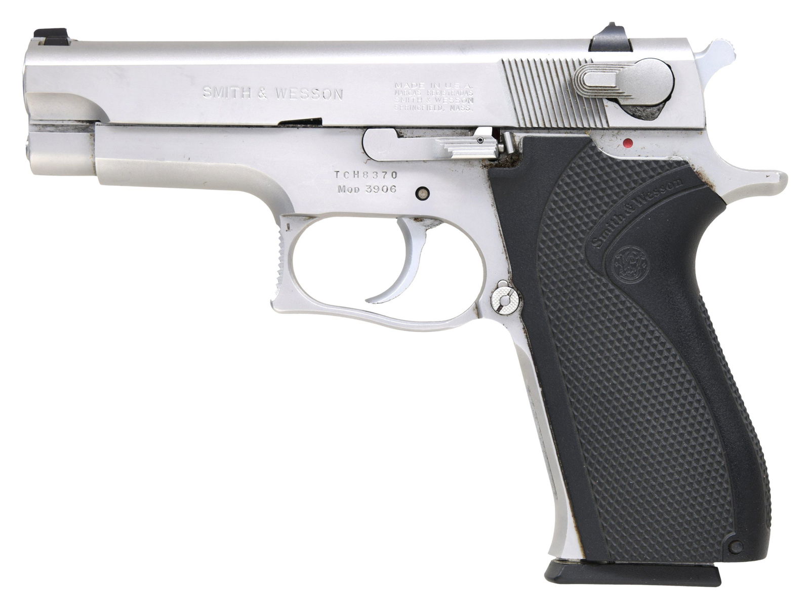 SMITH & WESSON MODEL 3906 SEMI AUTO PISTOL.: Cal. 9mm. S# TCH8370. Bbl. 4 1/4". Three-dot sights. Single-stack 9mm DA S&W pistol. Stainless finish. Black checkered grips with S&W logo. MAGS: One 9-rd. CONDITION: Grips show some light handling ma