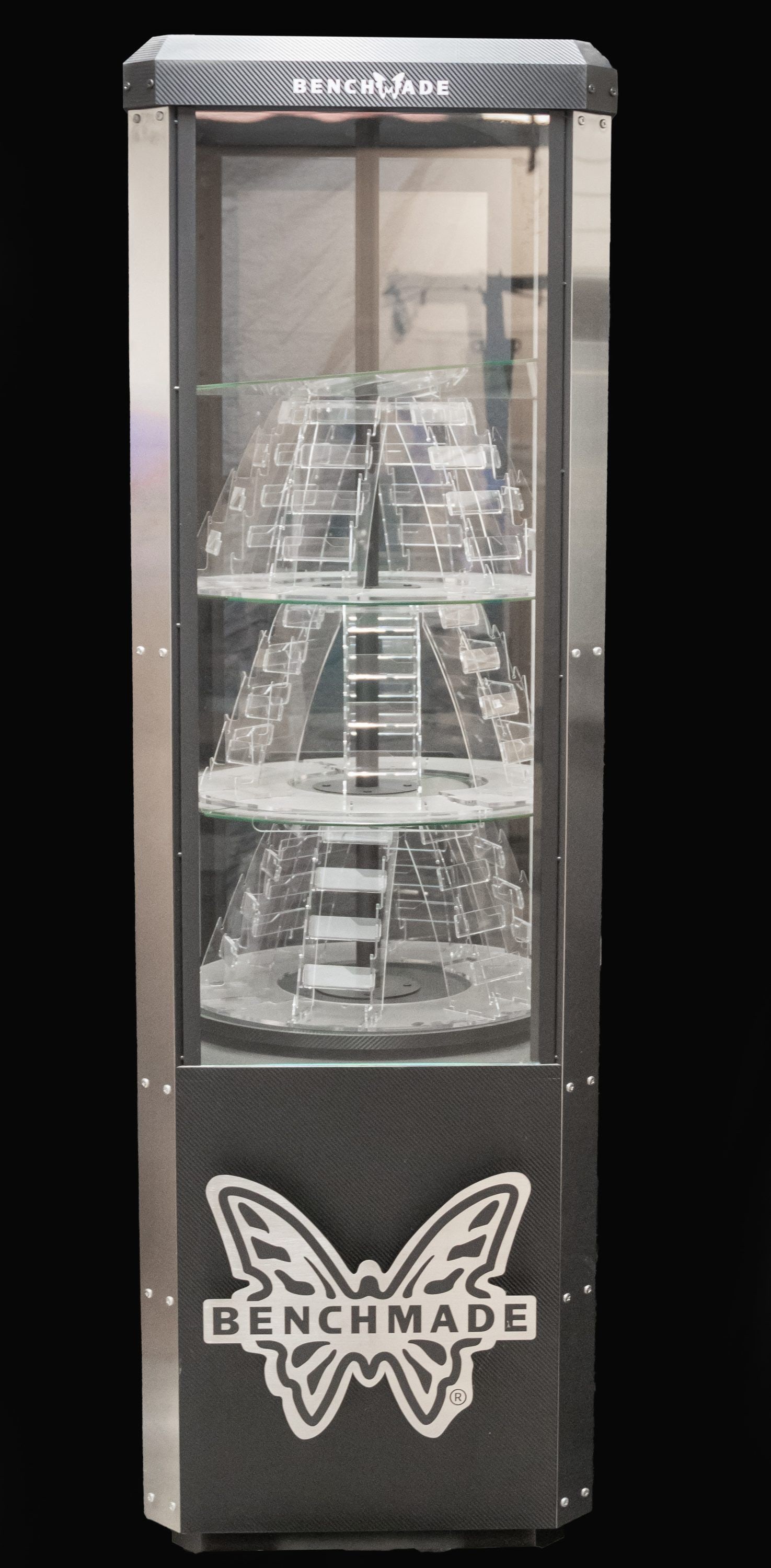 ATTRACTIVE BENCHMADE KNIFE RETAIL DISPLAY CASE.: Floor model display case has sturdy silver-colored metal & safety glass construction. Benchmade butterfly logo on front of display case. Case measures 77" tall, 24" wide & 24" deep. The display area i