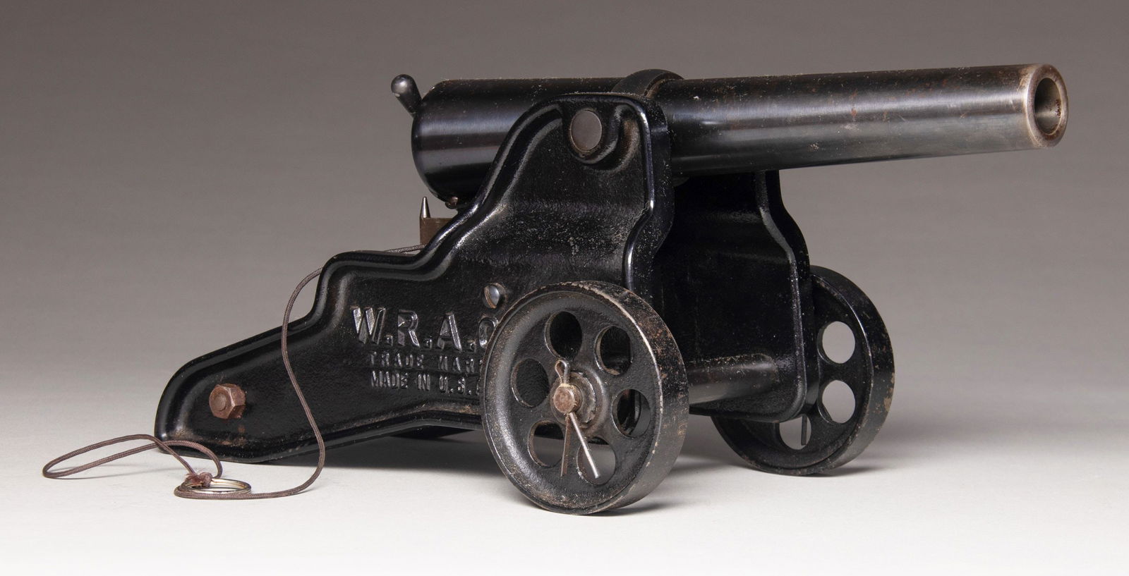 BELLMORE-JOHNSON TOOL COMPANY WINCHESTER: BREECHLOADING SIGNAL CANNON. Cal. 10 GA, 2 7/8" for blanks only. S# S1080. Bbl. 11 3/4" with Bellmore-Johnson markings. "Japan Black" finished iron carriage with 3 1/2" iron wheels. Sides of carriage