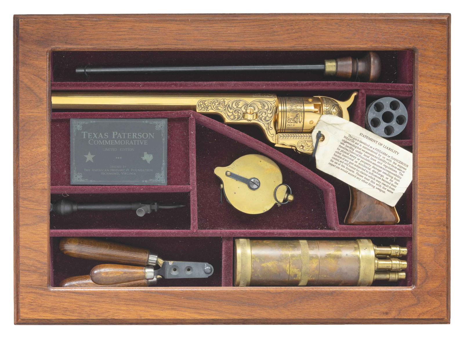 AMERICAN HISTORICAL FOUNDATION TEXAS PATERSON GOLD: REVOLVER. Cal. 36. S# 332. Bbl. 9". Bead front sight. Number 332 of only 950 units made in 1988 to commemorate the iconic Colt Texas Paterson revolver. Gold plated finish with floral scroll engraving