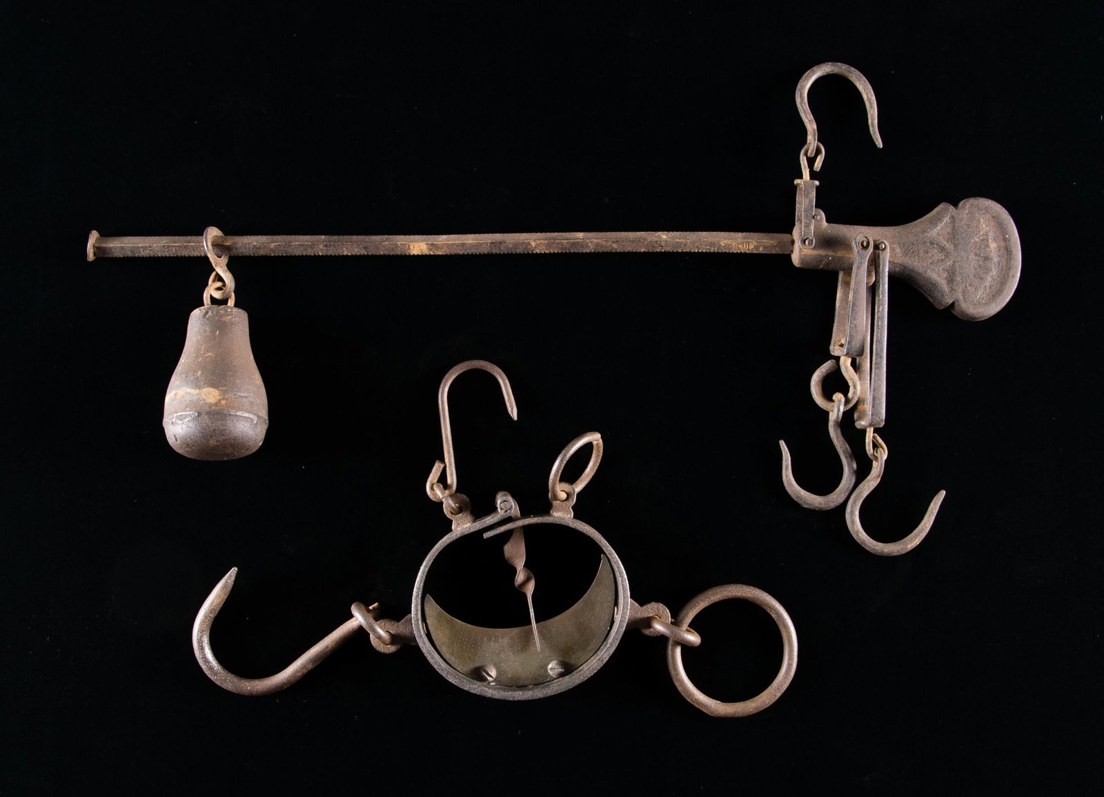 2 ANTIQUE SCALES.: This lot contains 2 antique scales. The first is a cast iron balance beam scale with 3 original hooks and counterweight. the other is a scarce buffalo hide scale used by hunters to weigh buffalo hides