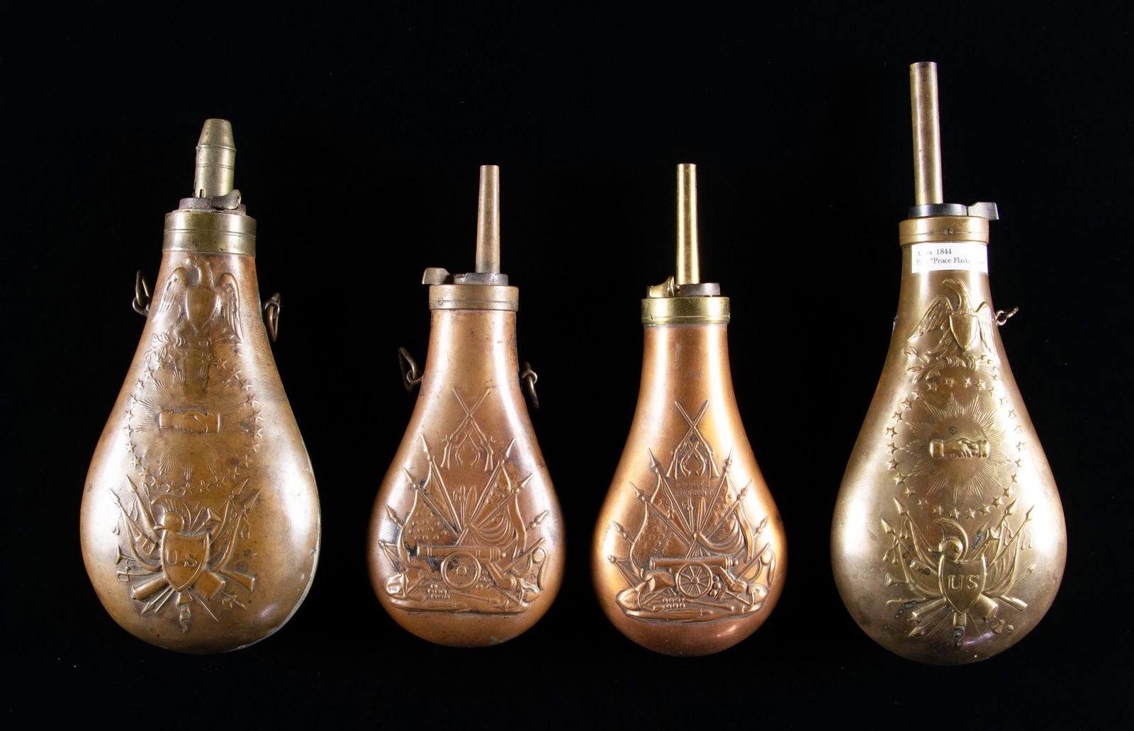 FOUR POWDER FLASKS.: 2 reproduction Colt flasks, one made by Dixson, original Mississippi rifle flask with altered charger, "WS" inspection on body, reproduction Mississippi rifle flask. CONDITION: good to very good overa