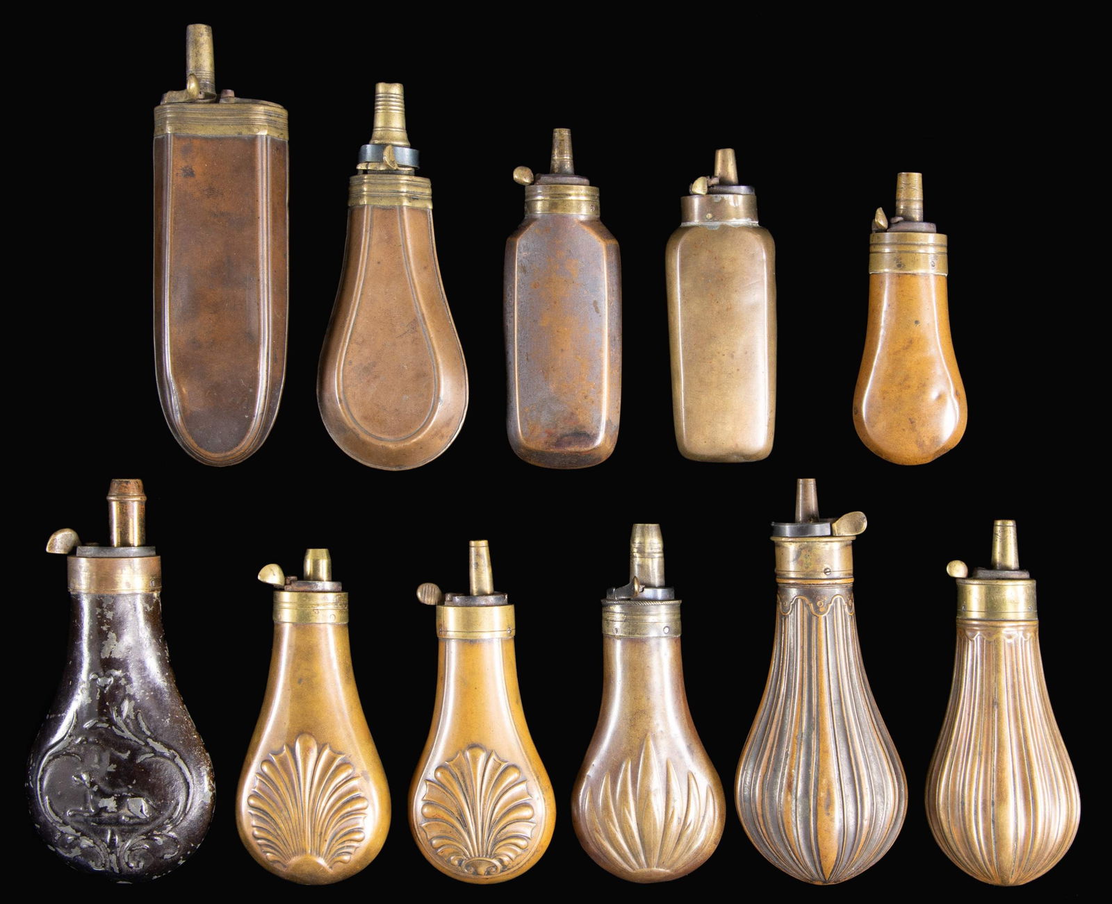 GROUP OF 11 DIFFERENT PISTOL POWDER FLASKS.: Ranging in size from 4" to 6", one unusual 6" with cap compartment next to charger. CONDITION: good to very good overall. PROVENANCE: The Esteemed Norm Greenberg Collection. (02-24848-20/JS). NON-GUN.