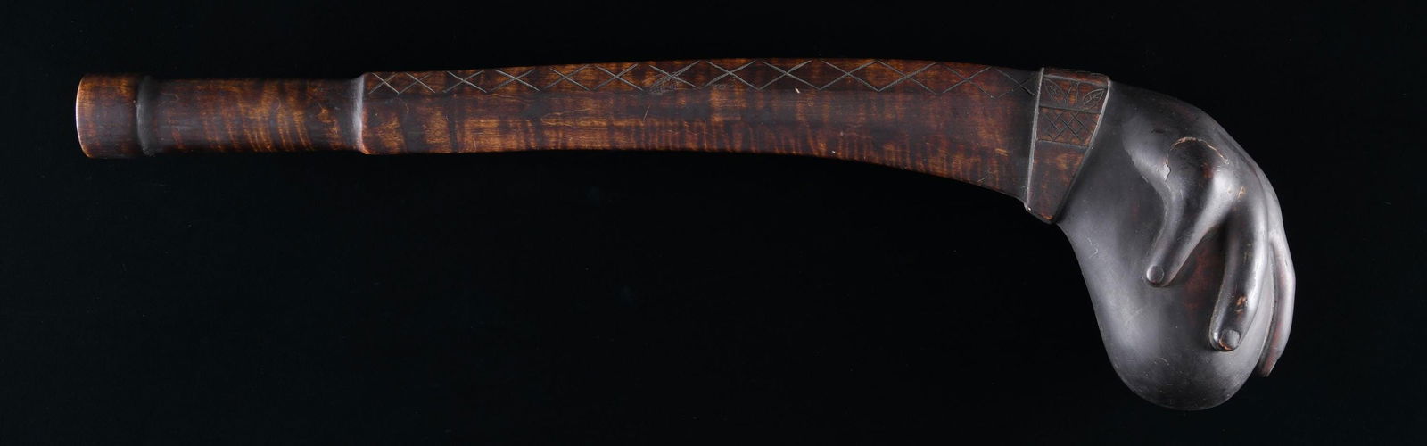 CONTEMPORARY CARVED NATIVE AMERICAN "HAND & BALL": WARCLUB. Contemporary copy of war club found in Midwest museum. 23" overall, sculpted and carved decorated handle terminating in 6" ball held by human hand. Consigner purchased this over 20 years ago
