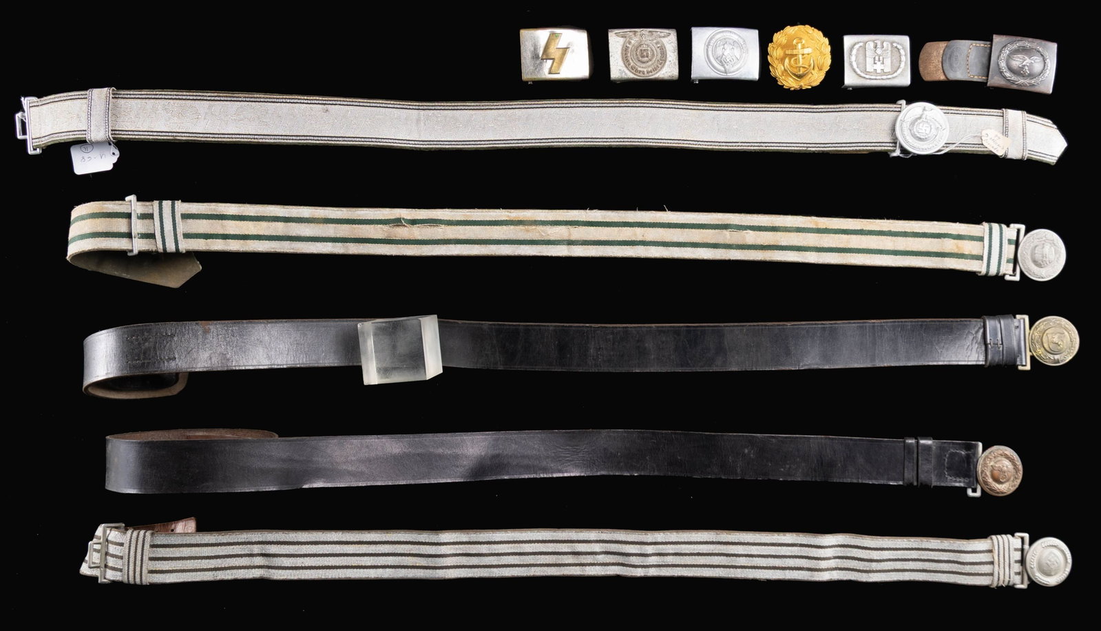 11 WWII GERMAN BELTS & BUCKLES.: This fine group of 11 belts and buckles from WWII Germany include 1 SS enlisted man's buckle likely manufactured late in the war by Overhoff. / 1 Westfalen fire officials belt and 2 -piece buckle. / 1
