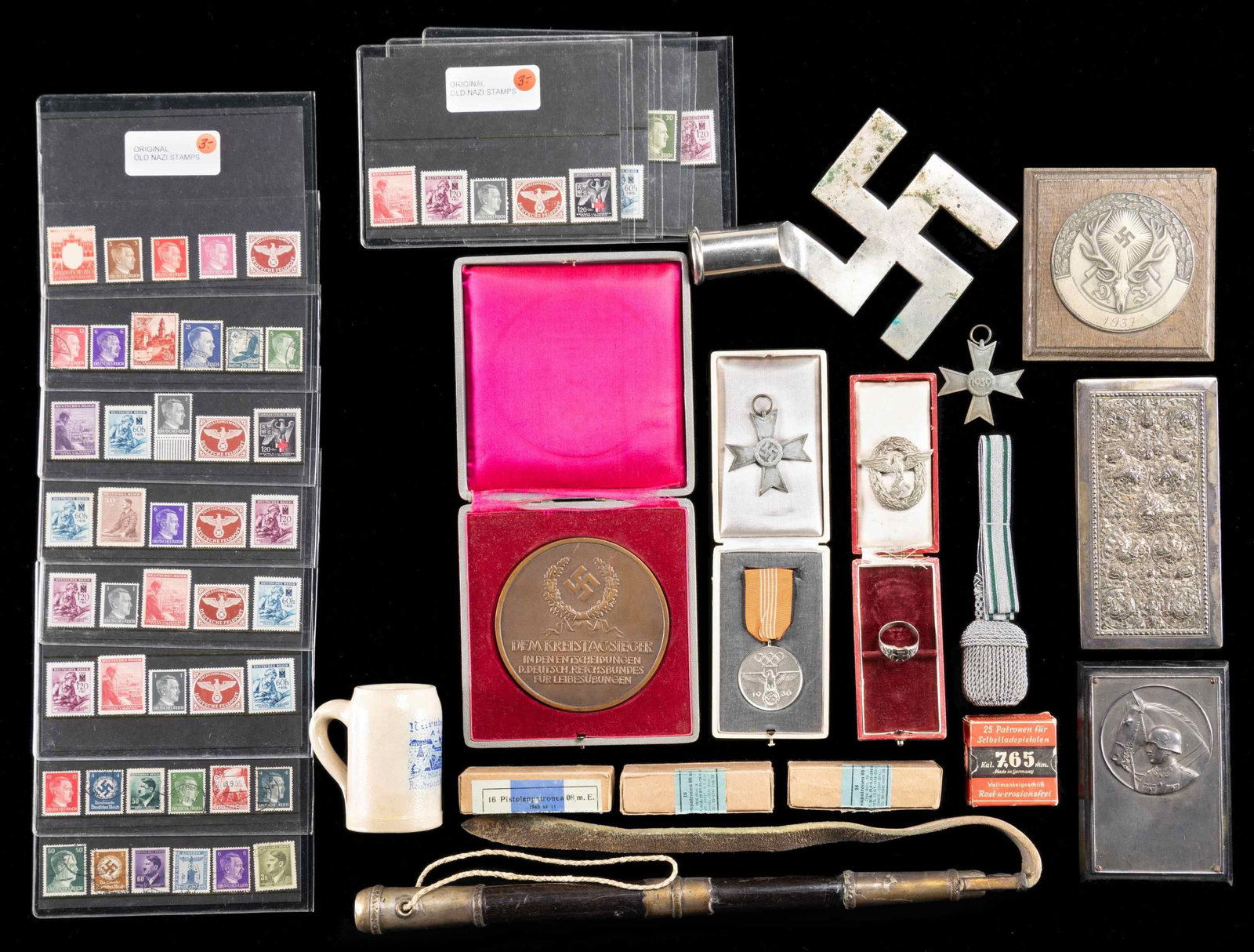 WWII GERMAN MEDALS, POLE TOP, DESK MEDALS & MORE.: This varied group includes 1 WWI Iron Cross finger ring. / 1 Police sword knot. / 1 Party symbol flag pole top. / 1 Small German youth wall plaque from 1937. / 2 Zinc War Merit crosses with out sword 