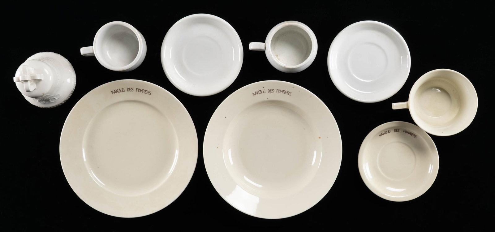 WWII GERMAN PLATE, BOWL, CUPS, SAUCERS & BELL.: This lot includes pieces from Adolf Hitler's Reichs Chancellery service and five other pieces. Individual pieces include 1 Cream colored plate of 9 1/2" with " KANZLEI DES FUHRERS written around part 
