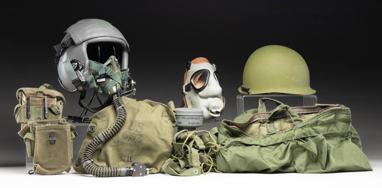 MIXED LOT OF USGI GEAR.: This lot consists of the following items: 1) Gray USAF aviation helmet. Rear has "WAGNER" name tag at rear. M-87/A1C microphone, air hose & green bag all present. CONDITION: helmet shows age related w