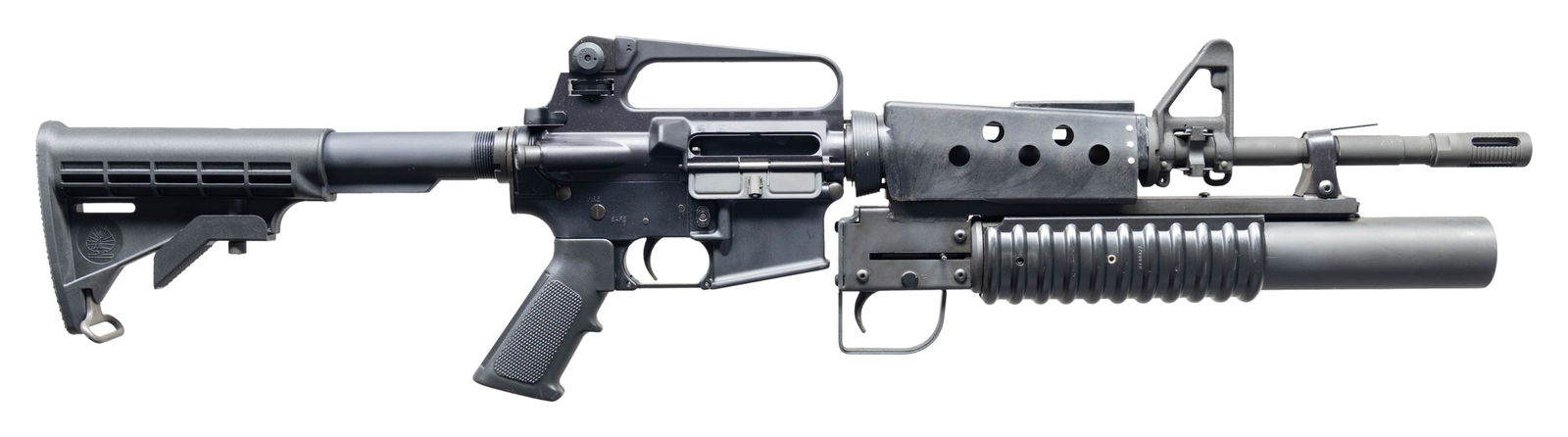 VERY NICE XM15-E25 CARBINE WITH 37MM FLARE: LAUNCHER. Cal. .223 / 5.56MM. S# L436943. Bbl. 16". Bushmaster Model XM15-E2S carbine w/ Cobray style 37mm flare launcher. M4 profile barrel, terminated w/ pinned flash hider. Protected post front sig