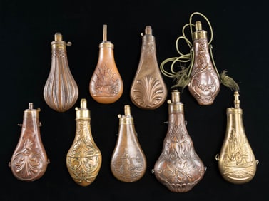 9 BRASS AND COPPER POWDER FLASKS WITH CHARGERS.