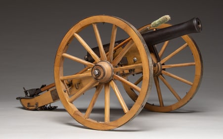 MINIATURE STEEL CANNON WITH CARRIAGE.