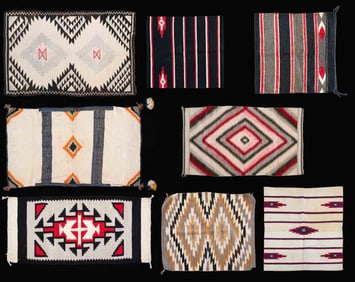 GROUPING OF 8 NAVAJO THEMED RUGS.