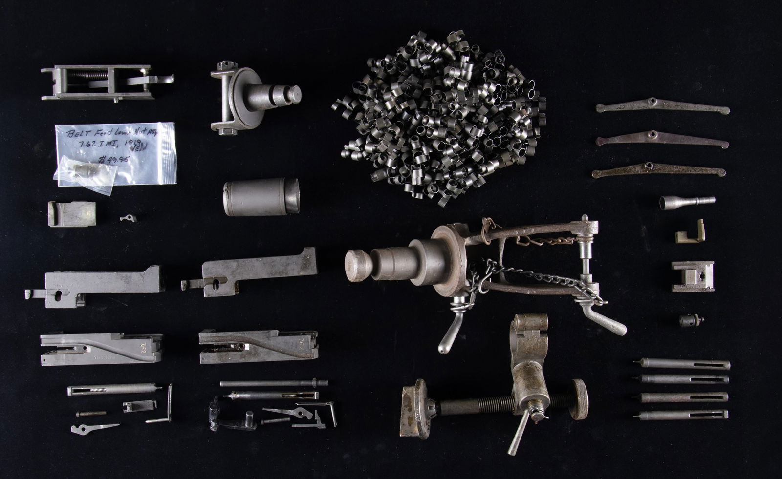 LARGE LOT OF BROWNING 1917/1919 MG PARTS.: This lot consists of the following Browning MG parts: 1) M8 Barrel Cover New condition. 2) 1917 Tripod Leather Strap New condition. 3) 1917A1 Leveler Leg NOS condition. 4) Tripod Pintle for both 30 &