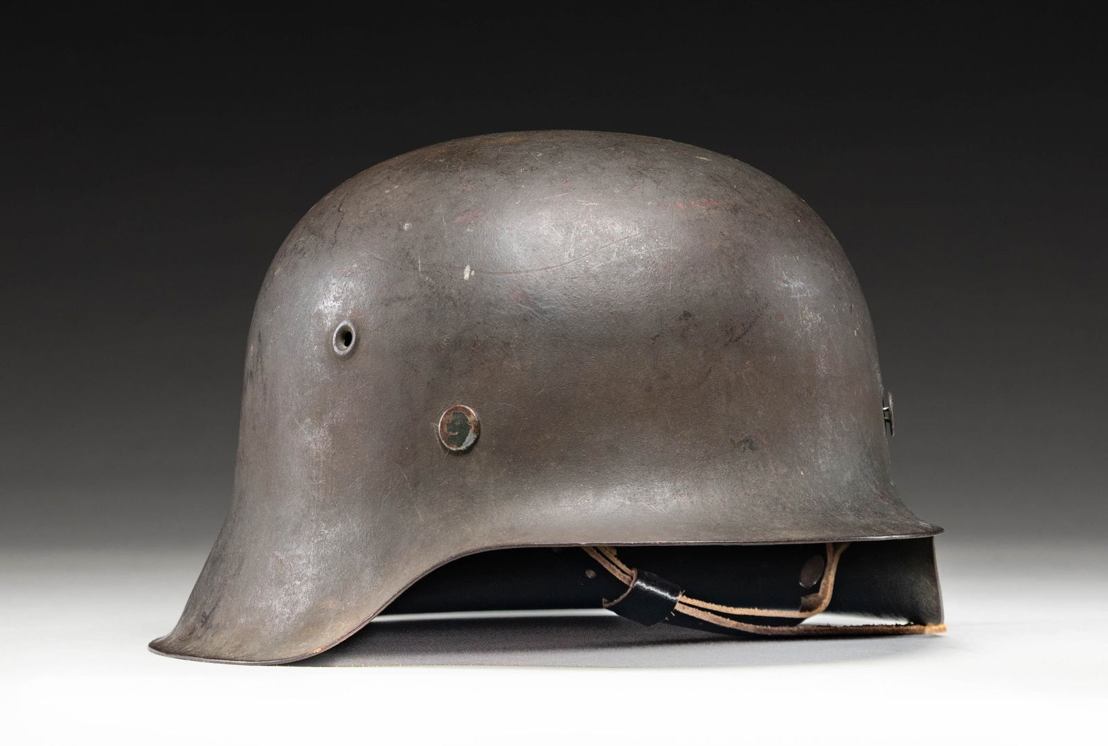 GERMAN WWII M42 STAHLHELM.: Iconic German M42 Stahlhelm mfg. during WWII. Interior is stamped with a partially discernible "CKL" mfg. code (Eisenhuttenwerke) followed by a "64" size mark above an apparent "20". Helmet exhibits a
