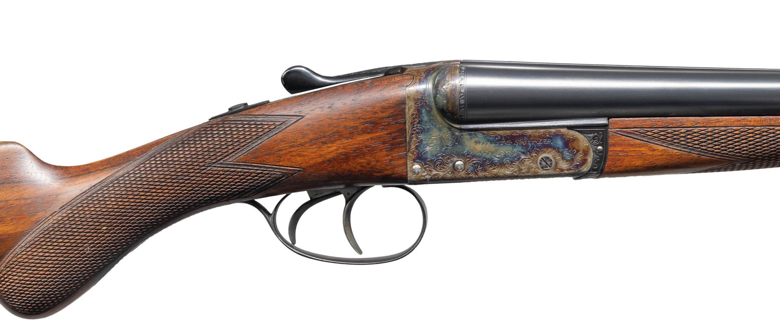 WEBLEY AND SCOTT MODEL 720 BOXLOCK SXS SHOTGUN.: Cal. 20 ga. 2 3/4". S# 128376. Bbls. 26" with Birmingham address. Rib is importer marked "ABERCROMBIE & FITCH Co. Agents". Case colored boxlock action has 50% coverage of tasteful scroll engraving. Do
