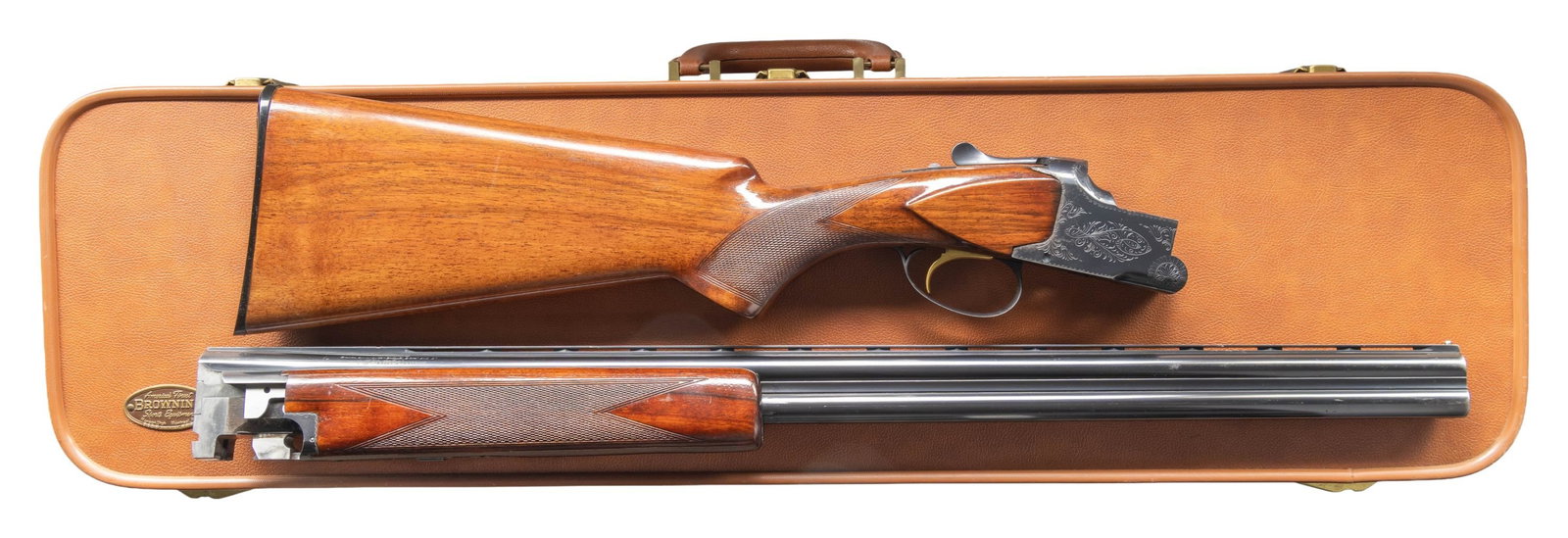 BROWNING SUPERPOSED LIGHTNING SKEET O/U SHOTGUN.: Cal. 20 ga. 2 3/4" and 3". S# 56133 V9. Bbls. 26 1/2" vent rib with fixed skeet and skeet chokes. Steel front bead. Blued action with standard grade 1 scroll engraving. Gold SST. Selective ejectors.