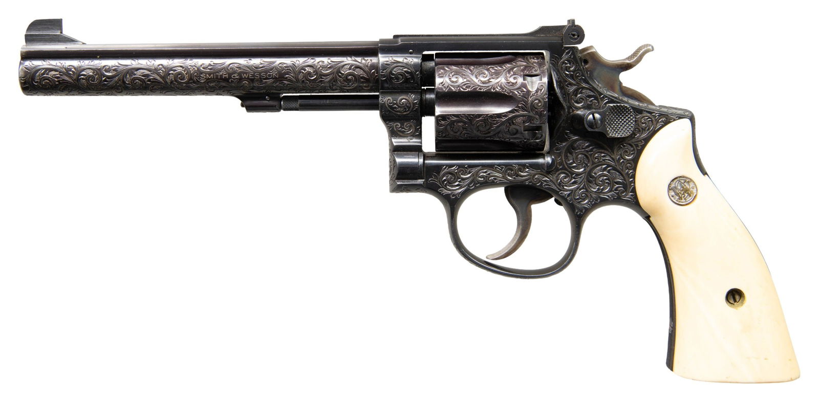 ENGRAVED S&W K-38 TARGET MASTERPIECE REVOLVER.: Cal. 38 Spl. S# K 302464. Bbl. 6" pinned with narrow serrations on its rib having 1/8" Patridge front sight; factory frame mounted Micrometer rear sight. Mfg. 1957; introduced 1946 and designated Mode