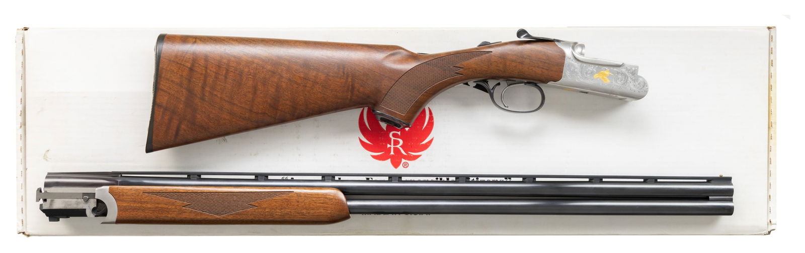 RUGER ENGRAVED 28 GA. RED LABEL O/U SHOTGUN.: Cal. 28 Ga. S# 420-21515. Bbl. 28" with Ruger marked Briley skeet chokes and without side ribs; has ventilated top rib plus brass bead front sight. Mfg. 2007 (2001-2011 for this model; 1994-2011 for a