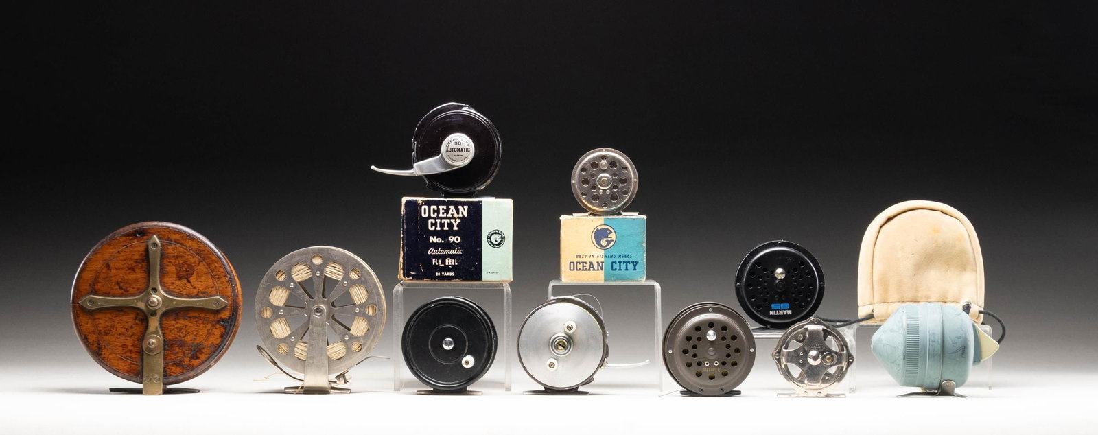 MISC. VINTAGE FISHING REELS (MOSTLY FLY).: 1) 6" diameter "Nottingham" wooden fly reel with horn knobs and star brass base with click. Marked "SUN" and with 1885 patent date on brass star. CONDITION: fine with many knocks and scrapes original