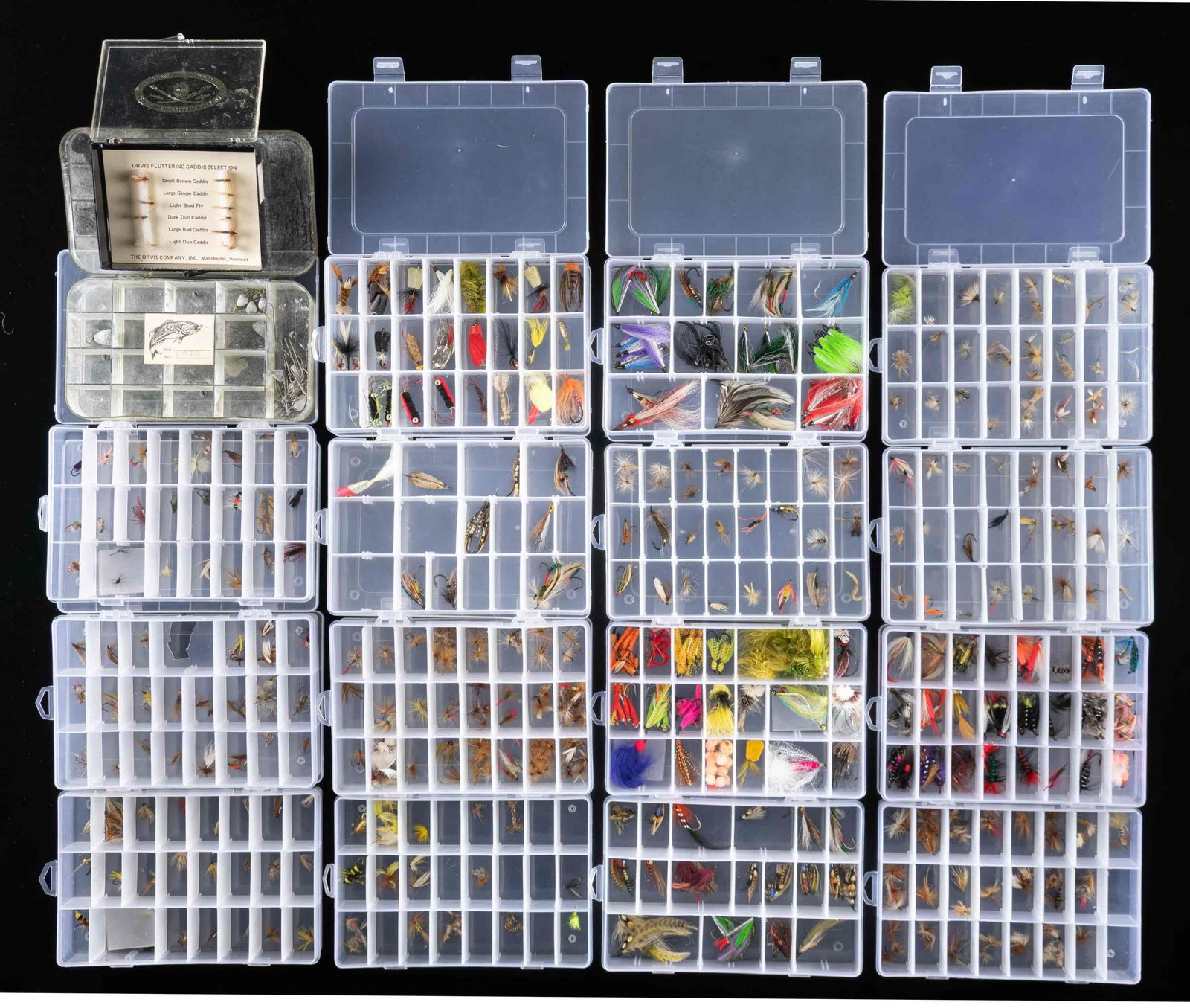LARGE LOT OF TROUT FLIES.: 1) 16- 8" x 5" x 1-1/2" plastic boxes containing 100s of smaller trout flies both dry and wet. CONDITION: fine; appear unfished. 2) 1- plastic box Orvis "Fluttering Caddis Selection" containing 10