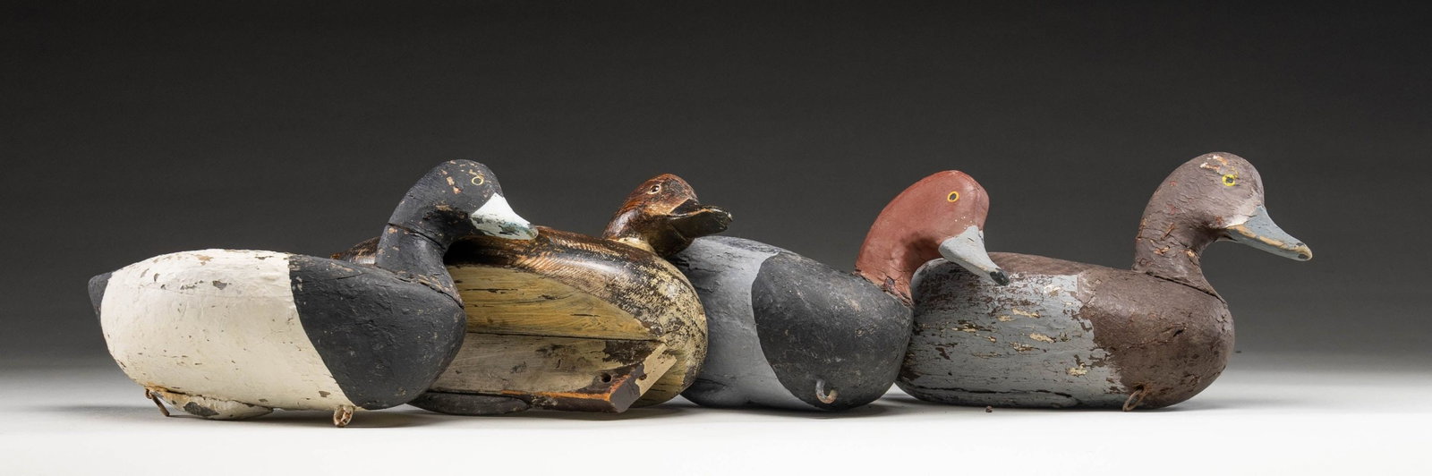 4 OLD DECOYS - PR OF REDHEADS & PR OF BLUEBILLS.: 1) Redhead drake measures 14" solid body, painted eyes. CONDITION: over painted. 2) Redhead hen measures 12-1/2" solid flat body with keel, slightly turned head, glass eyes. CONDITION: old paint