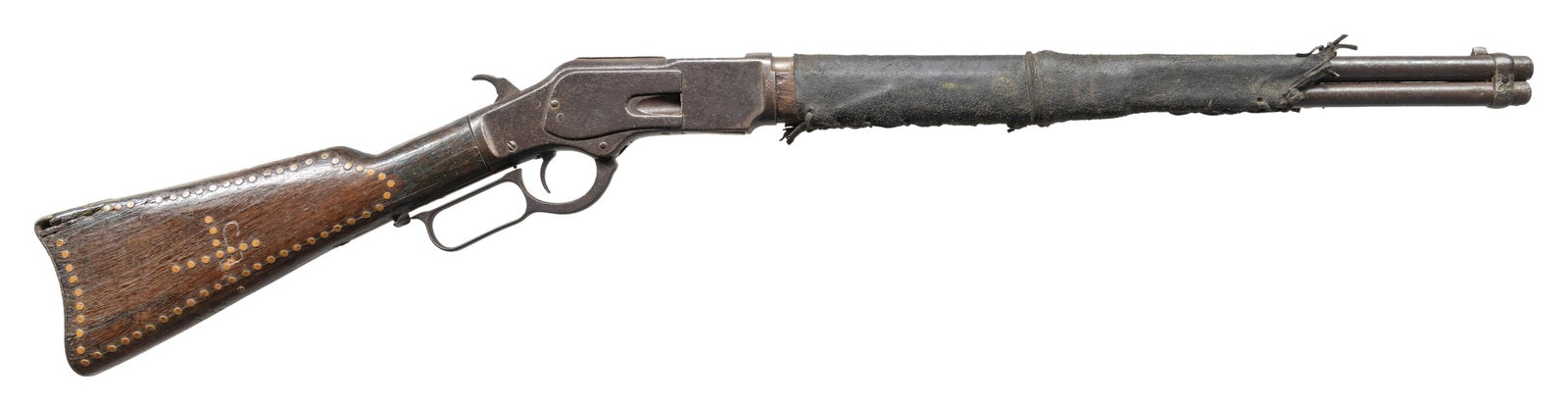 WINCHESTER 1873 TACK AND LEATHER ADORNED LEVER: ACTION CARBINE. Cal. 44 WCF. 944-40). S#. partially intact 151_16. Bbl. 20" carbine style. Full length mag. Saddle ring on left side of action has been removed, the dust cover is detached. Walnut