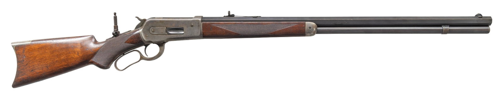 WINCHESTER MODEL 1886 DELUXE LEVER ACTION RIFLE.: Cal. 40-65 WCF. S# 83855. Bbl. 26" octagon. Lyman No. 4 hunting front sight, original sporting rear sight, and added combination tang sight. Full length mag. Blue and case colored finish. Walnut forea