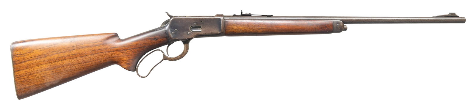 WINCHESTER 65 LEVER ACTION RIFLE.: Cal. 25-20 WCF. S# 1004128. Bbl. 22" w/ stippled ramp beaded front sight. Adjustable elevator sporting rear sight. Uncheckered pistol grip walnut stock set with checkered steel shotgun buttplate and s