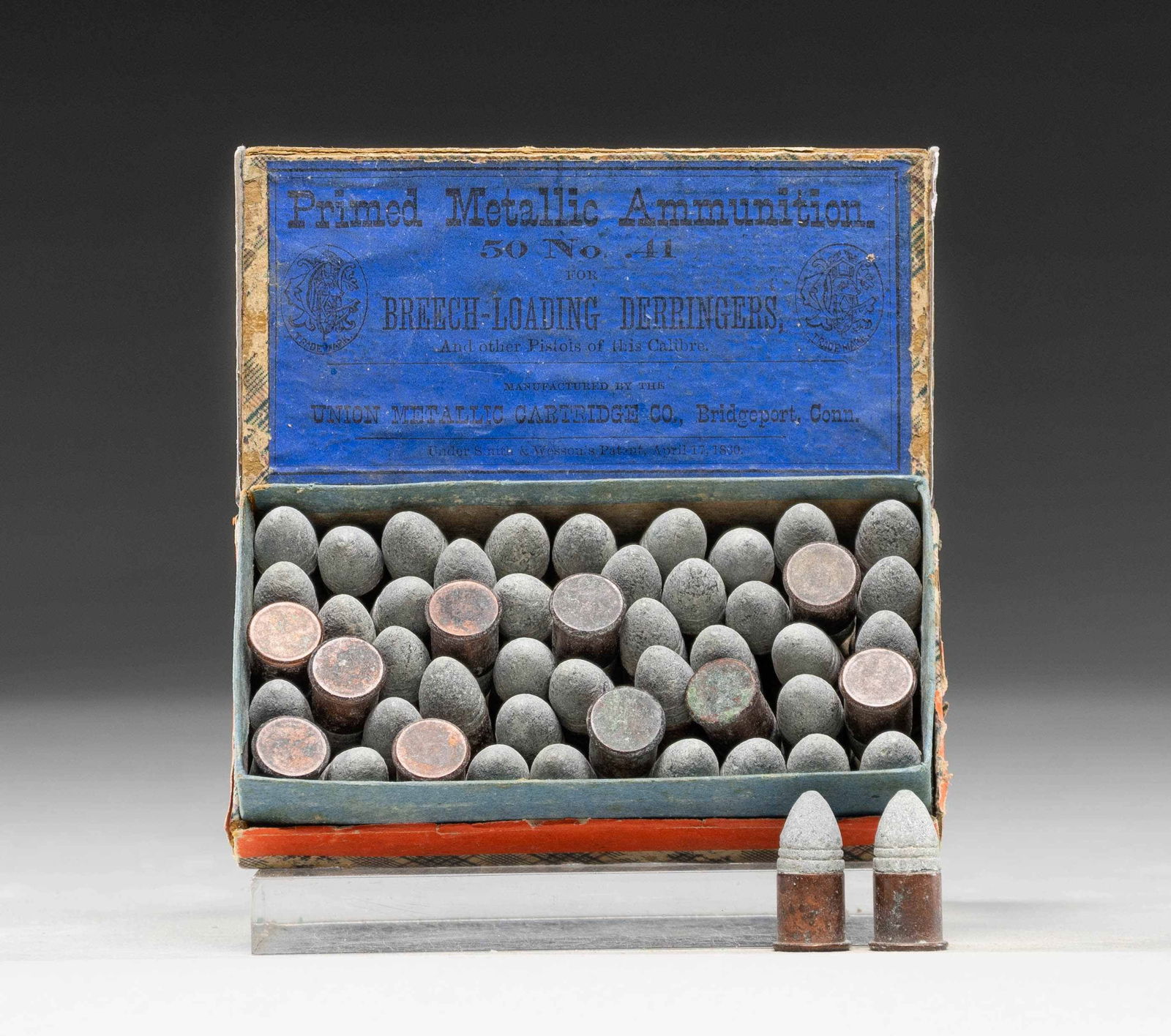 ANTIQUE BLUE LABEL BOX OF UMC 41 SHORT RF AMMO.: Nice, original box of 50 cartridges that would make a fine addition to a Remington derringer display. Blue label on box lid with orange seal around perimeter of sides. Opened box with 2 back corners