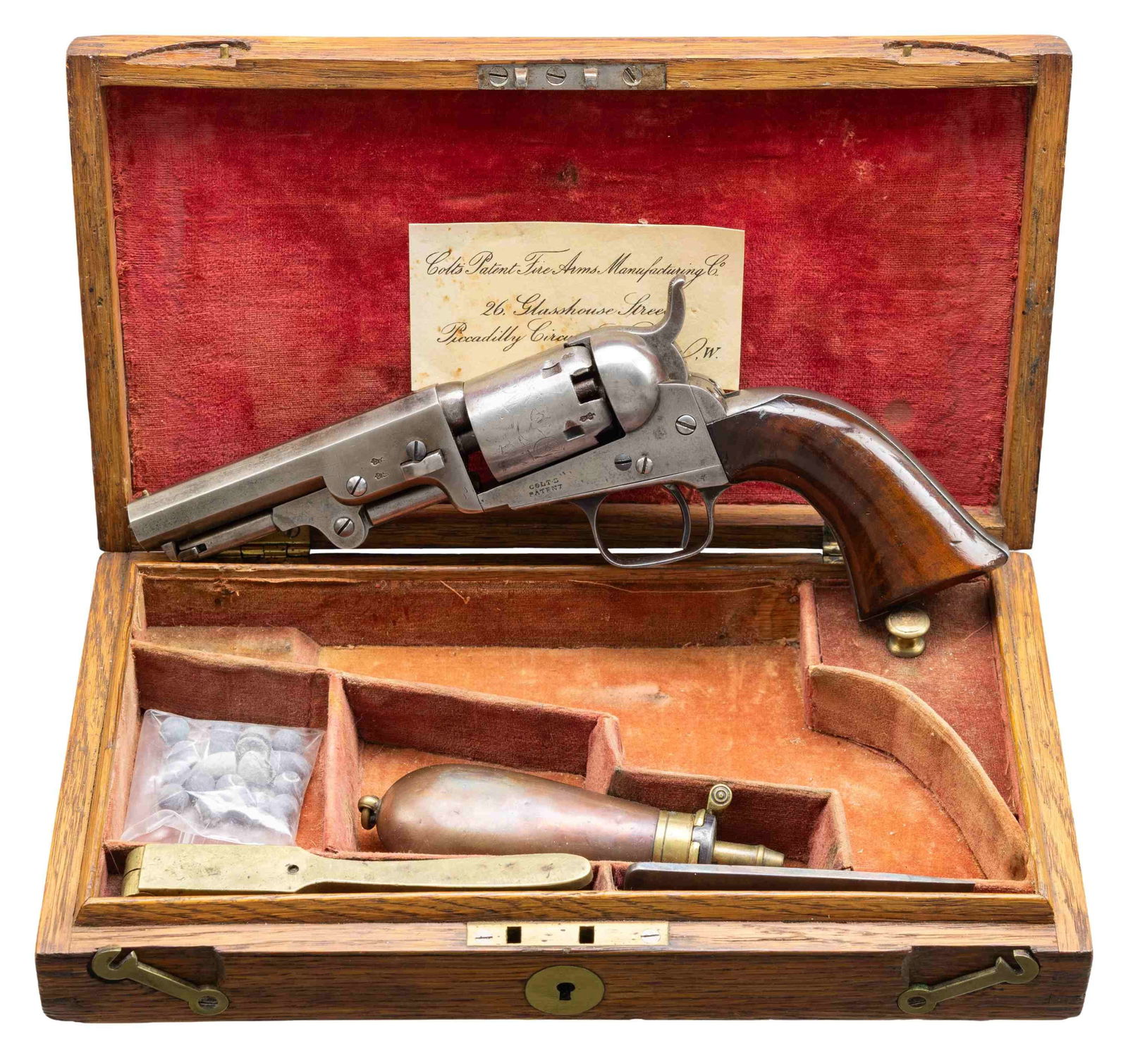COLT 1849 POCKET LONDON MODEL CASED REVOLVER.: Cal. 31. S# 8106. Bbl 4" oct with London address and steel bead. Left bbl flat and cyl have British proofs. 5-shot round cyl with stagecoach scene roll engraving. Frame, bbl, grip straps, cyl, loading