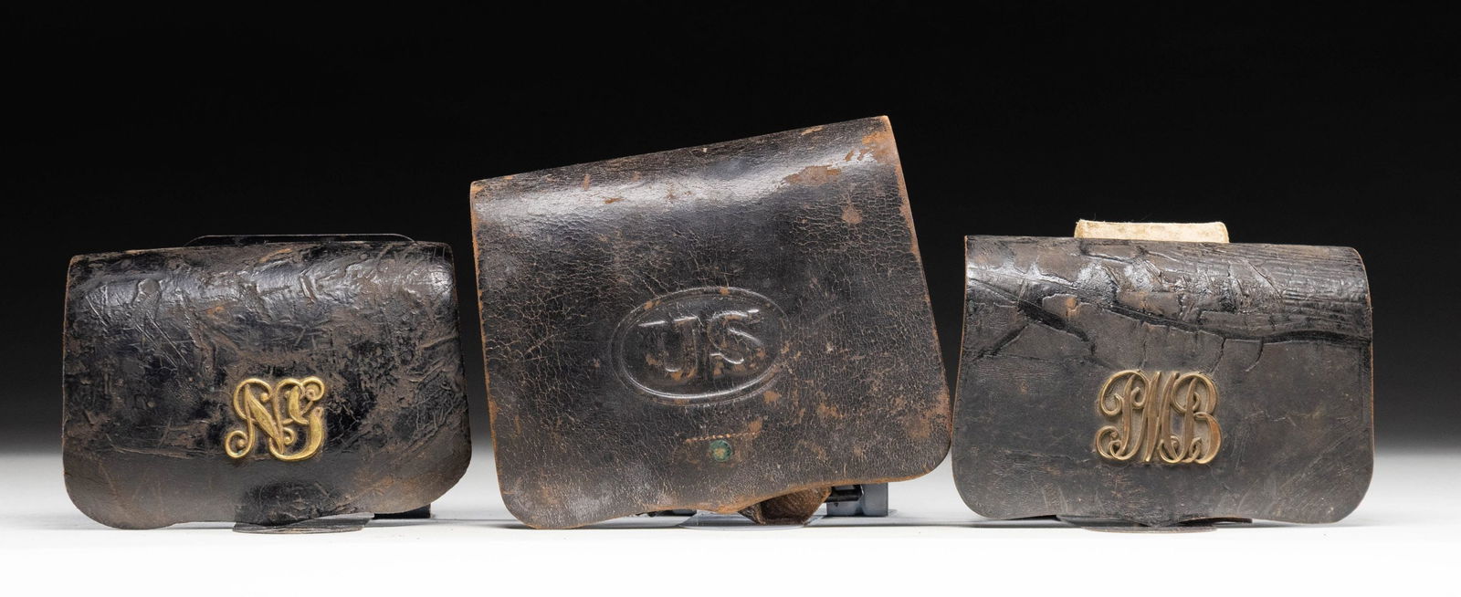 THREE CIVIL WAR ERA CARTRIDGE BOXES.: 1) Militia cartridge box with a "PMB" script plate on the front. An attached tag identifies this as the Portland Mechanic Blues of Portland, Maine. Interior has a wooden block with 16 drilled holes.