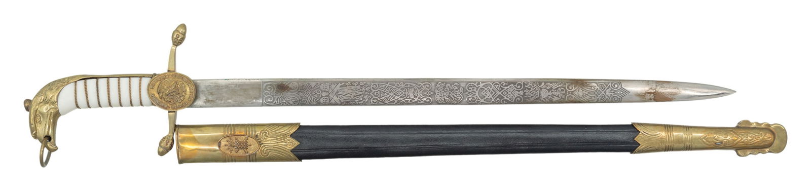 MEXICAN MILITARY ACADEMY SHORT SWORD WITH SCABBARD: Overall: 23". The 18" blade has 12" section of engraving that has Mexican patriotic themes. Brass guard has acorn tips & Mexican academy medallion. Wire & white composite grip. Brass eagle's head