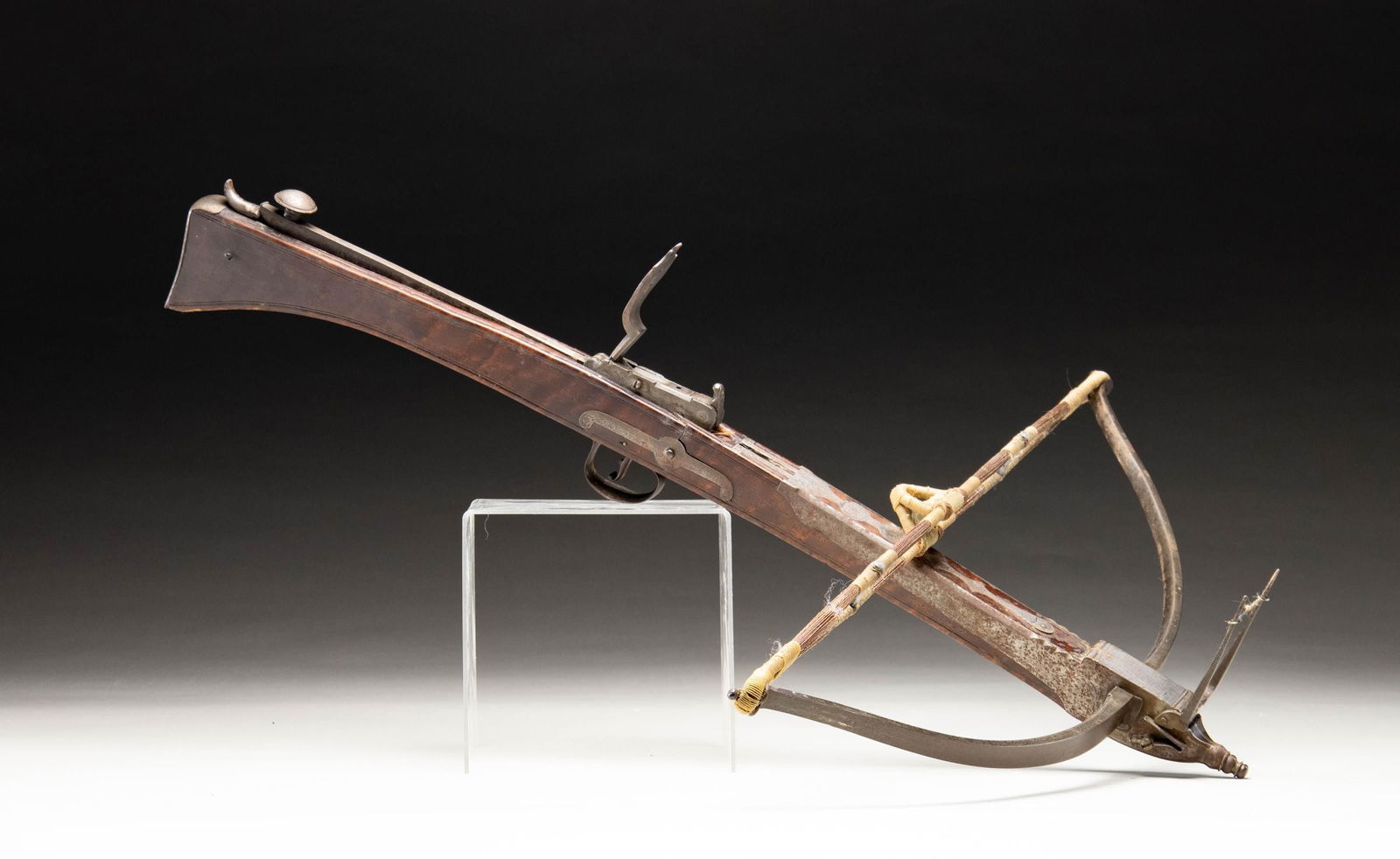 EARLY 19TH CENTURY BULLET-SHOOTING CROSSBOW BY: J. JOHNSON OF MANCHESTER, ENGLAND. This steel & walnut bow is 29.75" long with the bow being 24.5" wide. Folding cross-tree front sight on front tip of bow. Cocking lever also has the flip up peep