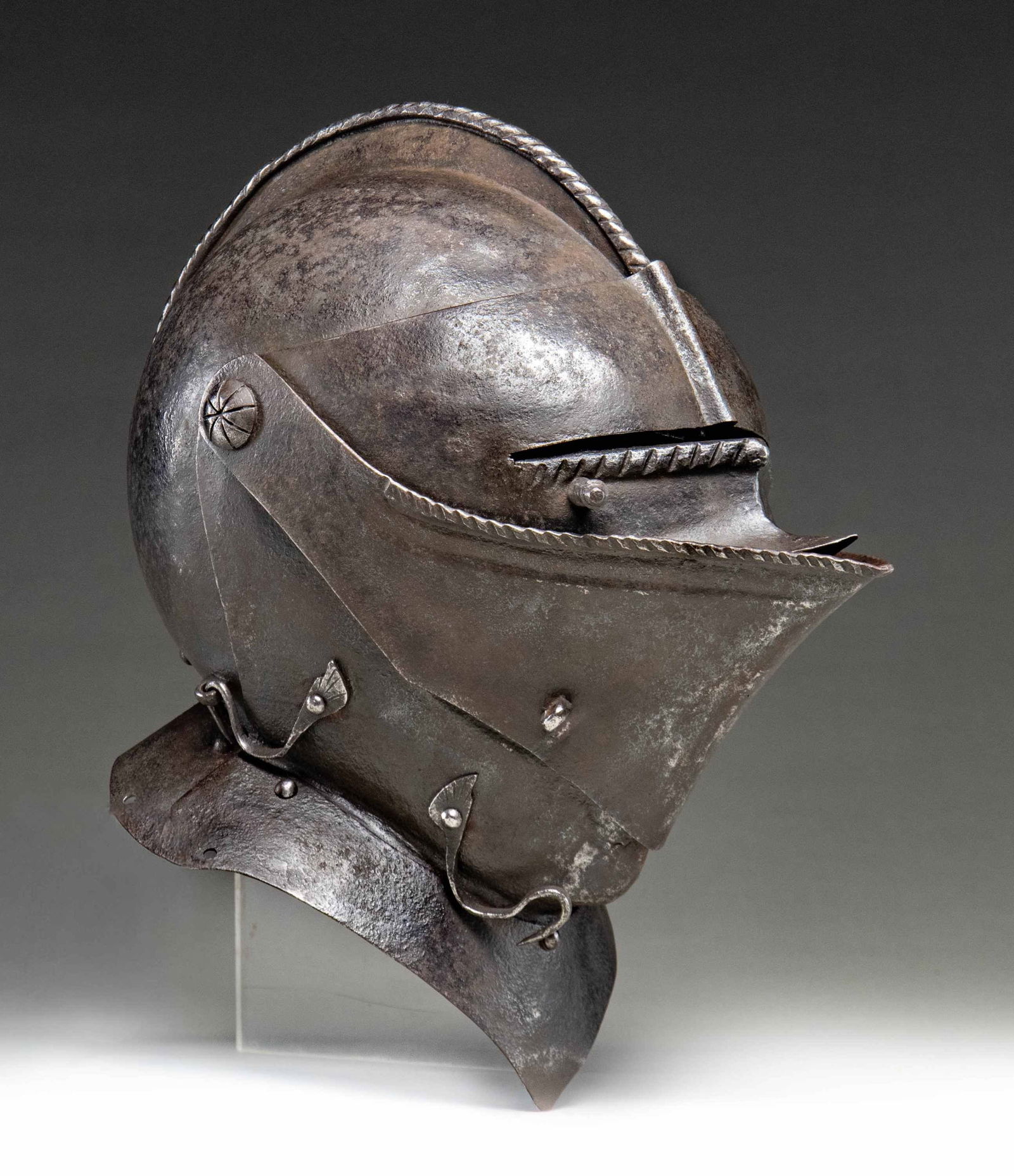 GERMAN OR ITALIAN CLOSED BURGONET HELMET.: A nice example of 16th or 17th century closed burgonet helmet of Germanic or Italian origin. The crown ridge has a simulated twisted cord edge as does the bottom of the eye slot and the top of the