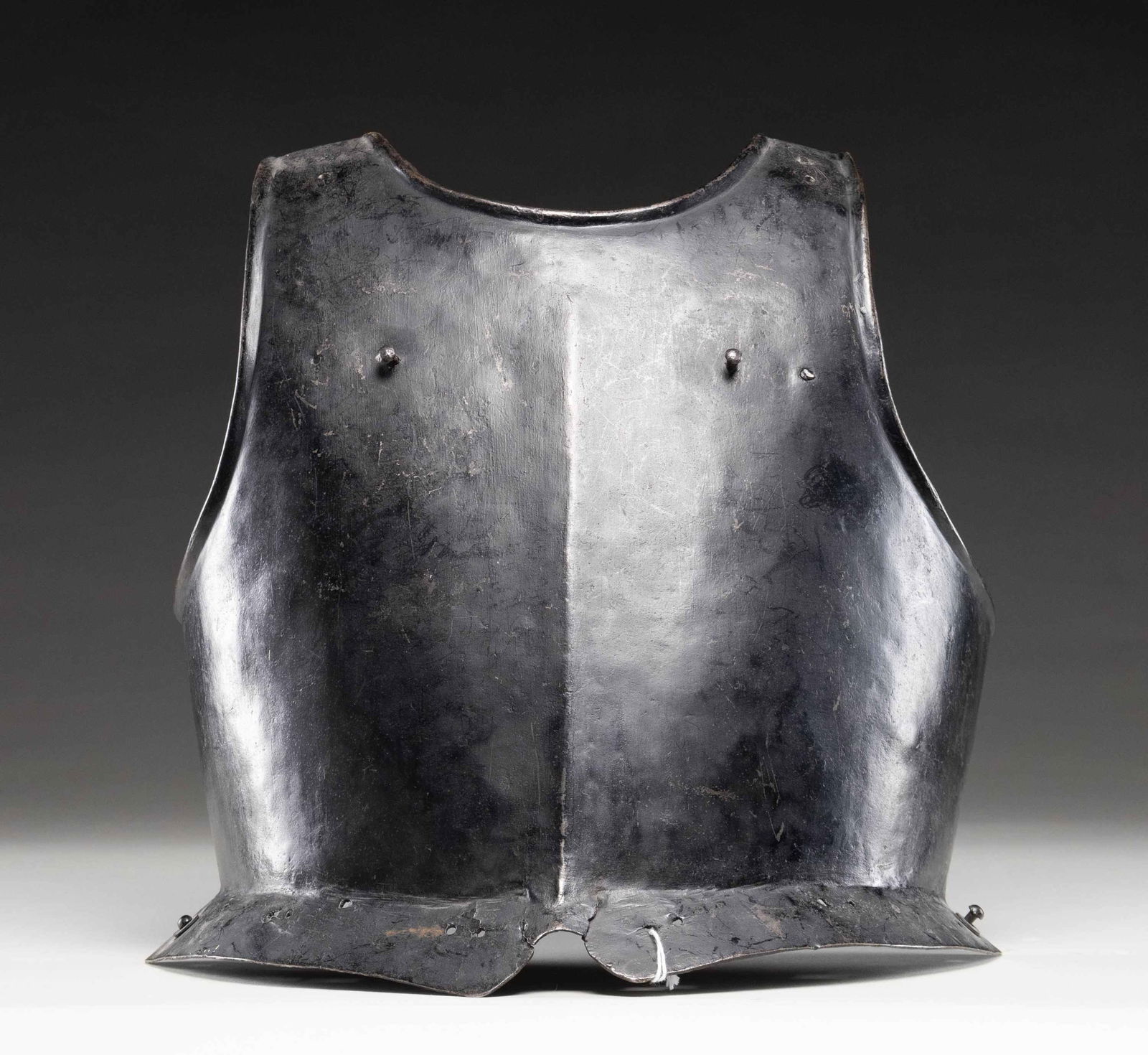 16th CENTURY ENGLISH BREASTPLATE.: This breastplate dates from the mid 16th Century and was likely worn by a pikeman. It measures approx 14 1/2" tall with a width of about 14". The breastplate shows a raised edge around the neck and