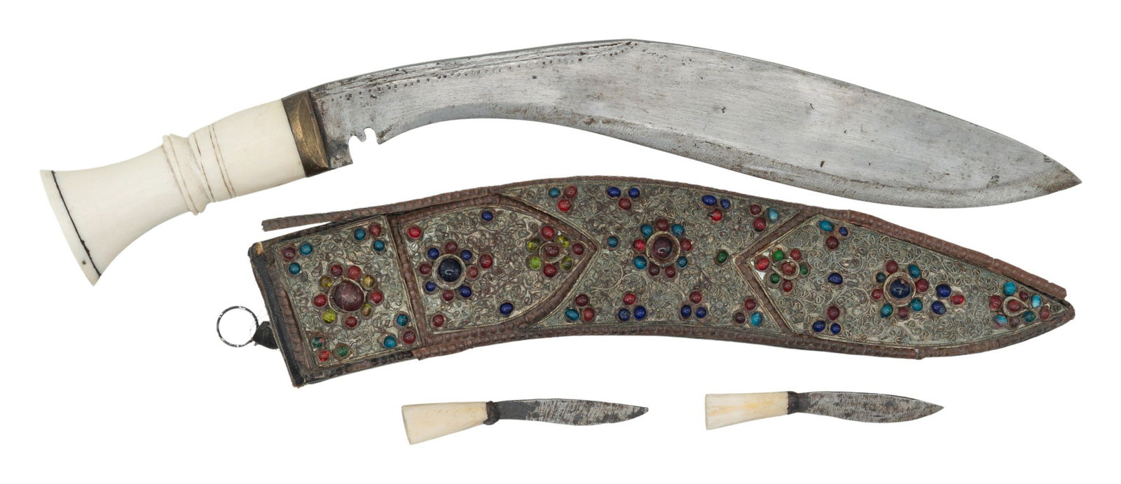 PRESENATION KUKRI KNIFE.: White colored bone handled Nepalese kukri knife. Blade measures 11" with 15" overall length. Two white handled ancillary knifes & scabbard present. Scabbard has low grade silver inlay with stones