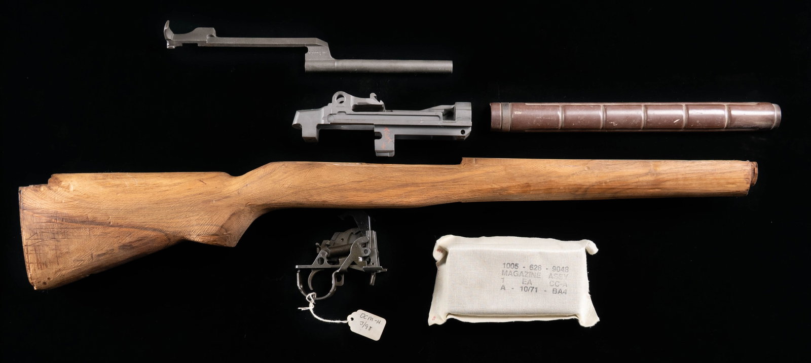 UNASSEMBLED SMITH ENTERPRISES M21 RECEIVER WITH: STOCK, & PARTS. Cal. 7.62mm. S# 002179. An unassembled Smith Enterprises M-21 receiver. Gray parkerized finish. Lettering has been filled in white for ease of reading. Unfinished, hardwood shoulder st