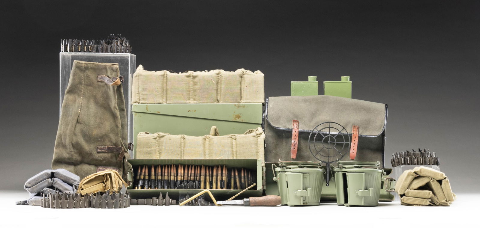 LOT OF WWII ERA & POST-WAR BANDOLIERS, AMMUNITION,: & MACHINE GUN ACCESSORIES. Lot of World War II era bandoliers, ammunition, and MG34/MG42 accessories, including: 1) x3 Turkish 7-cell tan cloth bandoliers, each containing 70-rds. (210-rds. total) of