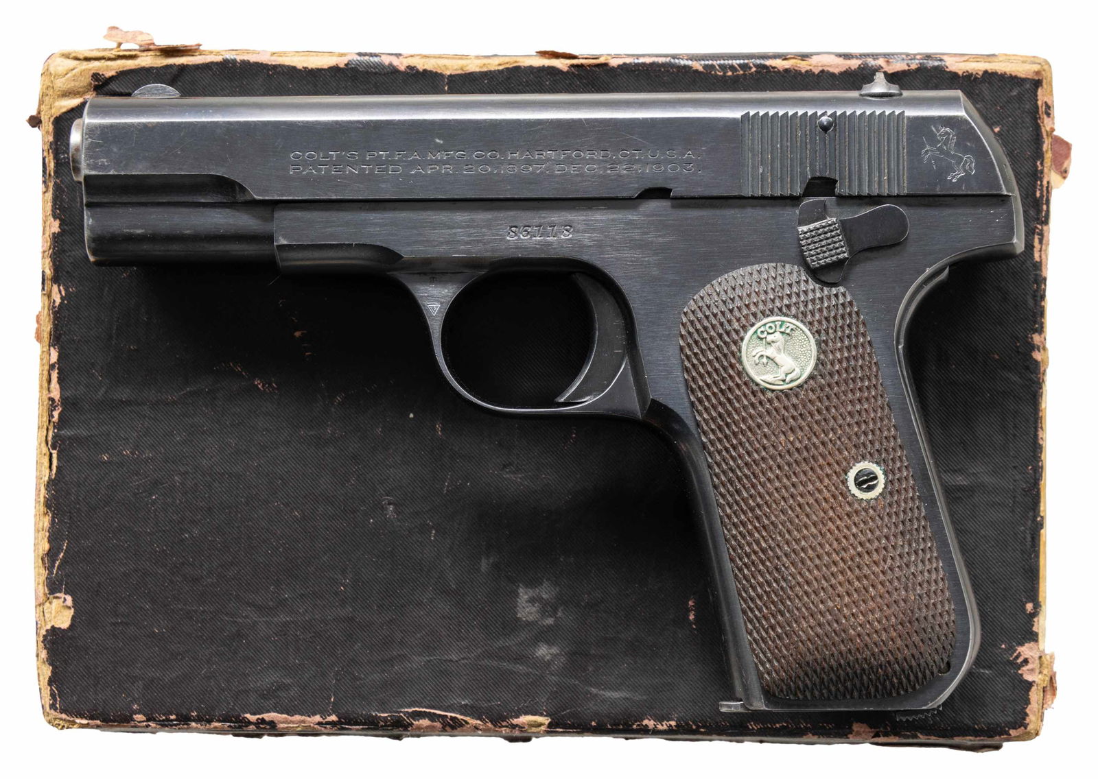 NICE COLT MODEL 1908 HAMMERLESS SEMI-AUTOMATIC: PISTOL WITH MATCHING FACTORY BOX. Cal. 380 ACP. S# 86118. Bbl. 3 3/4". Model 1908 Hammerless semi-automatic pistol mfg. by Colt. Left side of the slide is marked with Colt's 2-line mfg. and patent inf
