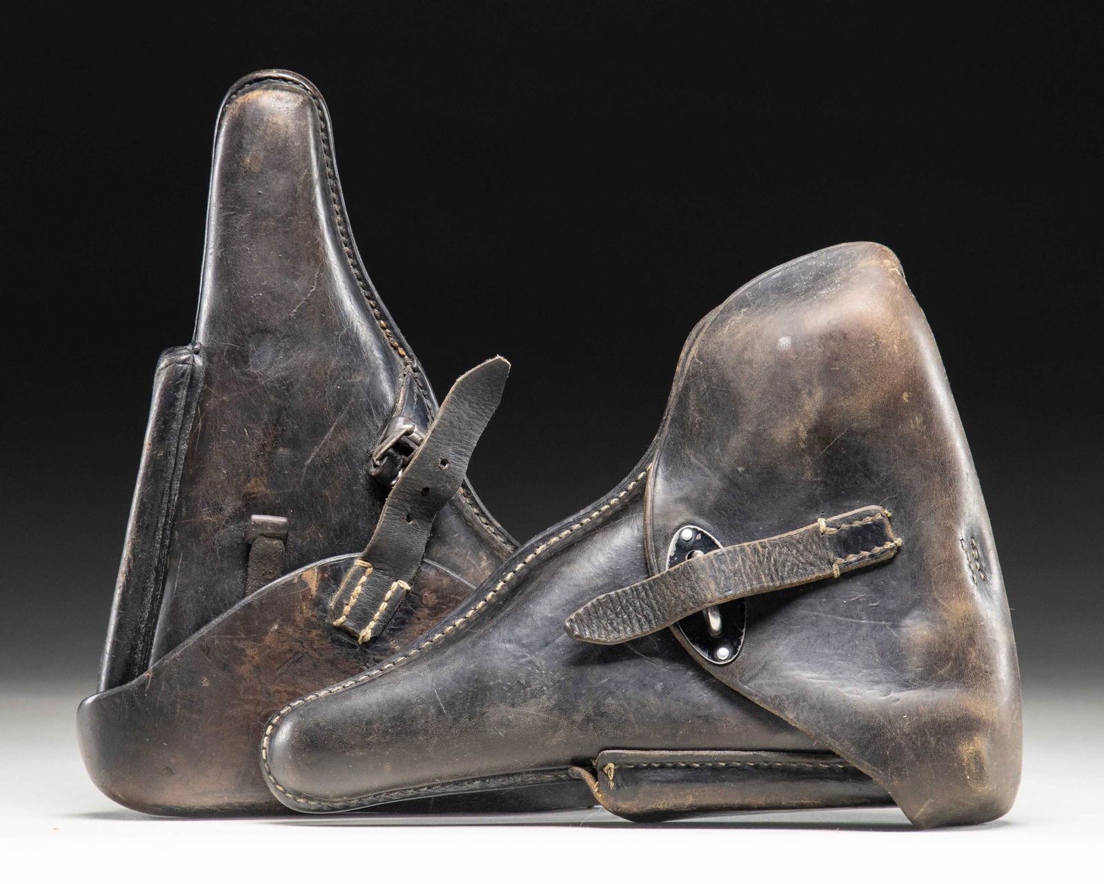 LOT OF 2 GERMAN P.08 & P.38 PISTOL HOLSTERS.: Lot consists of: 1) Brown leather P.08 Luger pistol holster mfg. by Hans Romer in 1936. Rear of holster is marked "HANS ROMER/ NEU-ULM/ 1936" between the belt loops, with a partially legible apparent