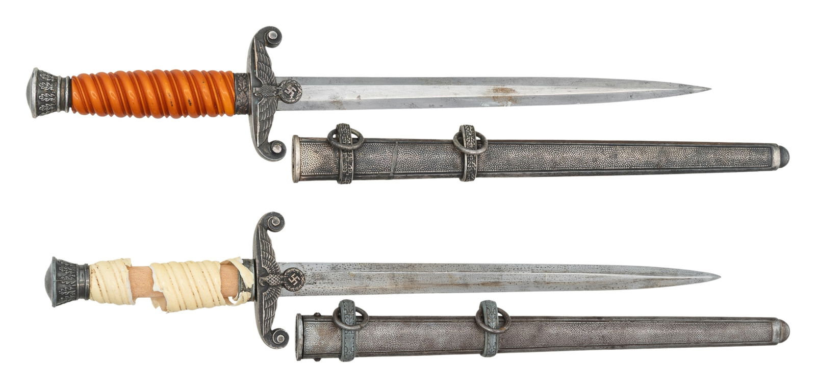 2 WWII GERMAN WEHRMACHT DAGGERS.: 1) WWII German Army dagger measuring 15 3/4" overall with a plain blade marked "F. W. HOLLER (logo) SOLINGEN". Plated eagle crossguard with oak leaf embellished pommel and ferrule. Dark orange grip an