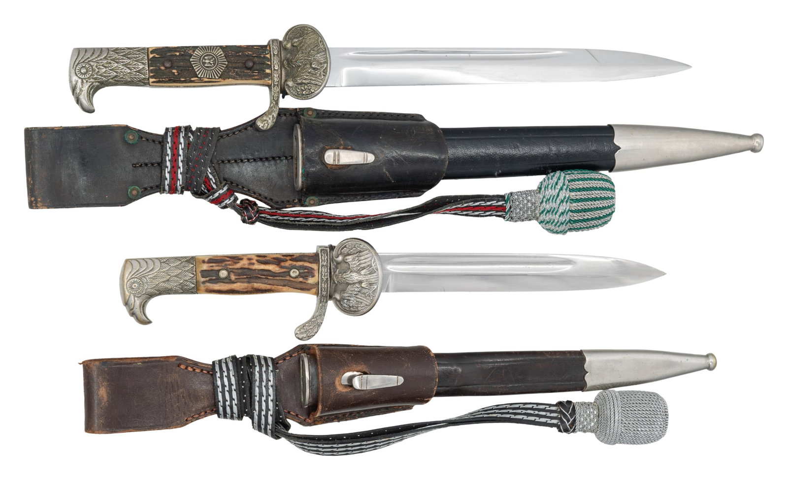 2 GERMAN WEIMAR REPUBLIC POLICE DRESS BAYONETS.: 1) Weimar Republic period German police dress bayonet measuring 15" overall with a plain single fullered unmarked 7 3/4" blade. Oak leaf decorated crossguard with a single clamshell guard showing a We