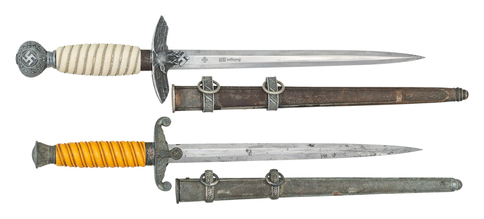 WWII GERMAN WEHRMACHT DAGGER AND LUFTWAFFE DAGGER.: 1) WWII German Army dagger measuring 15 3/4" overall with a plain blade marked "(logo) WKC SOLINGEN". Plated eagle crossguard with oak leaf embellished pommel and ferrule. Light orange grip and a plat