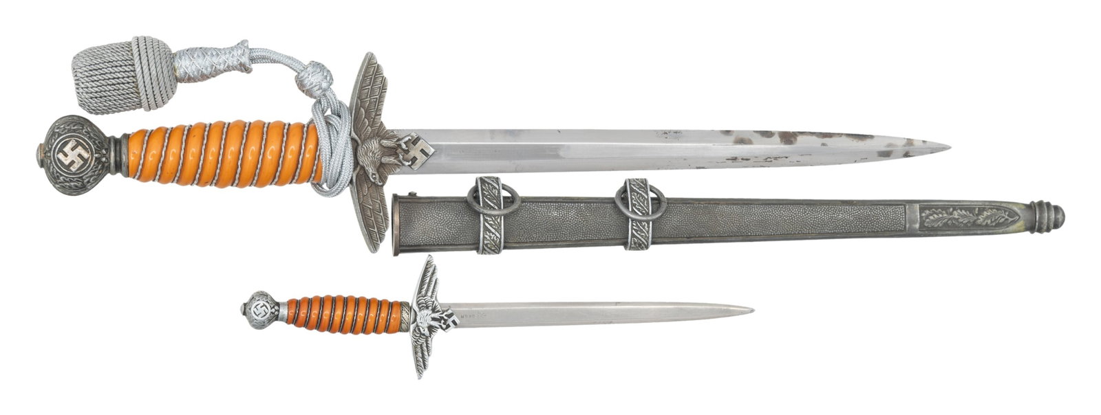 WWII GERMAN 2ND MODEL LUFTWAFFE DAGGER & MINIATURE: 1) A good example of a WWII German 2nd model Luftwaffe dagger measuring 17" overall with a plain blade marked "(logo) W K C SOLINGEN". Aluminum eagle crossguard with aluminum globular pommel decorated