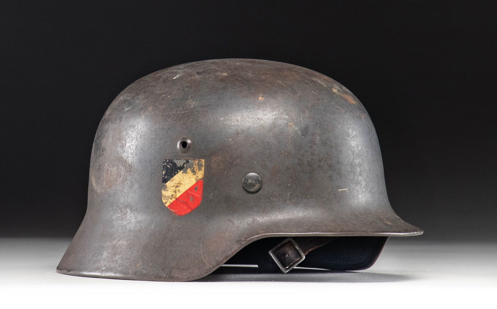 WWII GERMAN M1935 DOUBLE DECAL LUFTWAFFE HELMET.: Fine WWII German M1935 double decal Luftwaffe helmet in dark gray paint with a Luftwaffe decal on the left and and a National colors decal on the right. The interior rear is stamped " 4198 " and the