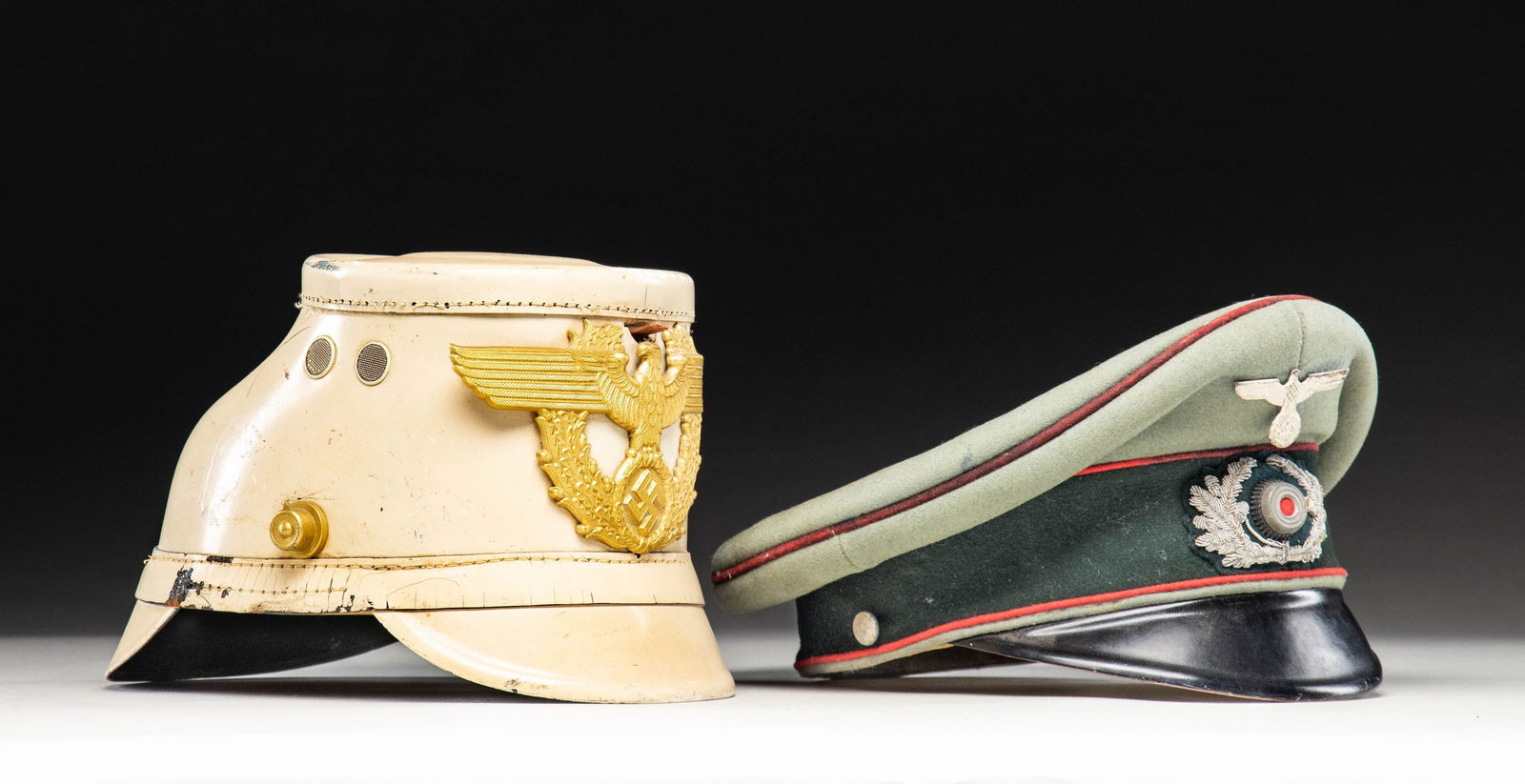 WWII GERMAN EARLY ARMY VISOR CAP AND WHITE TRAFFIC: POLICE SHAKO. 1) Very nice early WWII German Army Artillery visor cap. The cap has a light sage green crown with a dark green band and red piping throughout. The front of the crown has an early silver