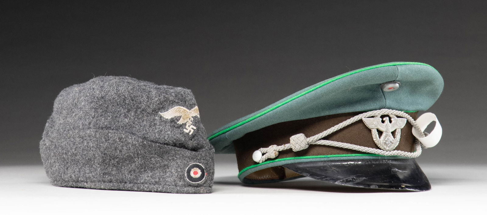 WWII GERMAN POLICE VISOR CAP & LUFTWAFFE SIDE CAP.: 1) WWII German Police official's visor cap. Deep sage green crown with a brown band and bright green piping. The front of the crown has a national cockade and the front of the band has an aluminum pol